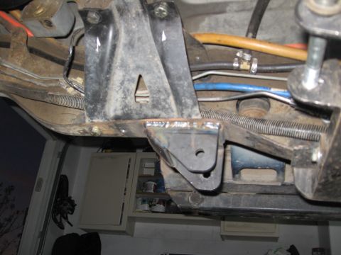 1994 Ford Bronco - Welded bracket modification on a vehicle's undercarriage, showing fuel lines and wiring.
