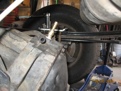 1994 Ford Bronco - A close-up view of a vehicle's rear axle and leaf springs, a brass fitting attached to a component, with a date stamp of 02/10/2008 visible.
