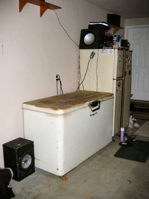 1985 Ford LTD Crown Victoria - Garage scene with a chest freezer, two refrigerators, and audio equipment.
