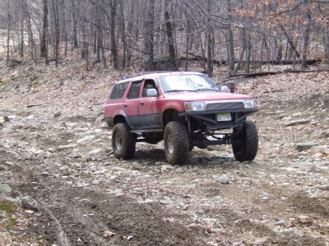 1976 Toyota Land Cruiser - This modified SUV navigates a challenging off-road course with large tires and a custom bumper.