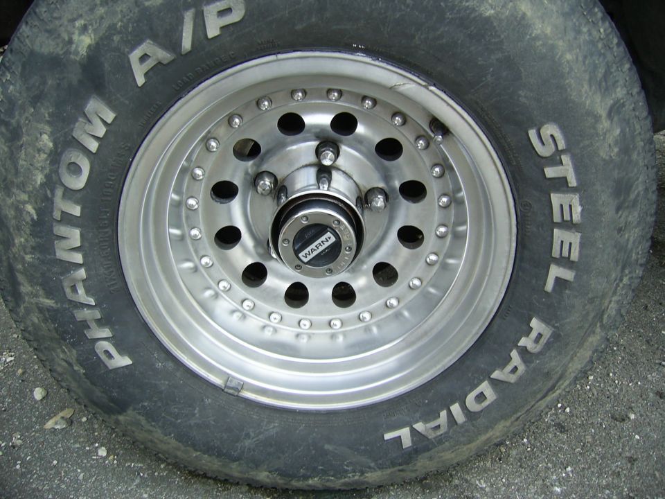 Close-up of alloy wheel with Phantom A/P tire and Warn locking hub center cap