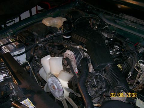 1995 Mercury Grand Marquis - Engine bay of a 1995 Mercury Grand Marquis, the intake manifold and other engine components.