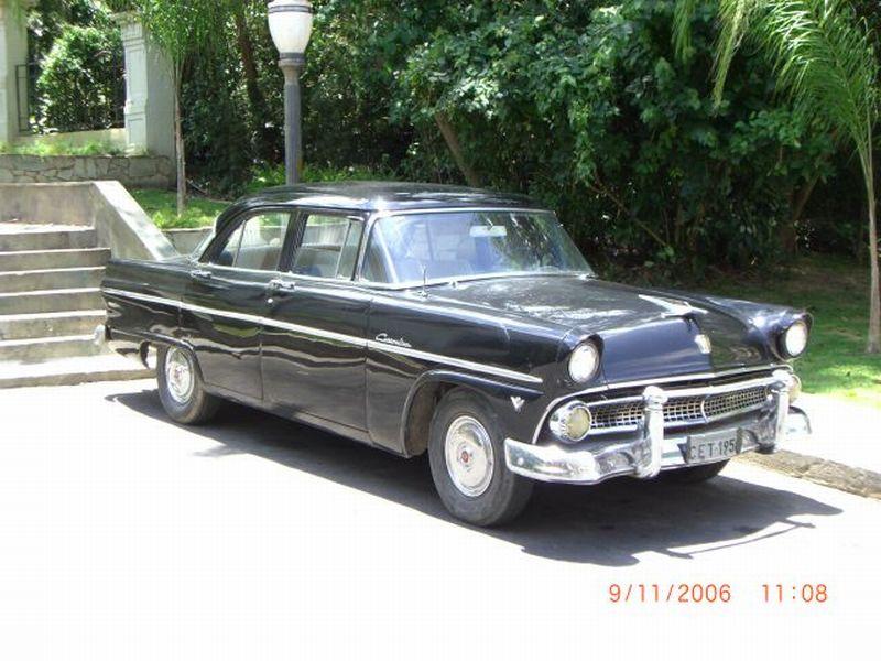 Black vintage 1950s four-door sedan parked on a paved driveway