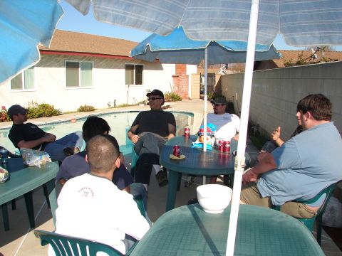 1992 Ford Taurus - Friends relax by the pool on a sunny day, enjoying drinks and conversation.