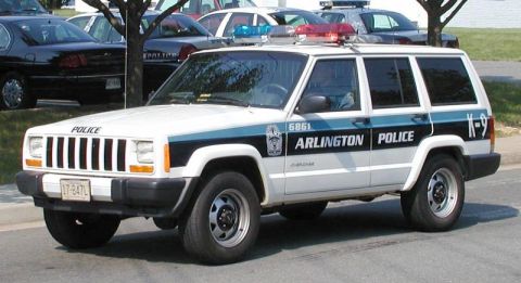 1991 Ford Crown Victoria - Arlington Police Department Jeep Cherokee SUV, marked with "Police" and K-9 unit designation.