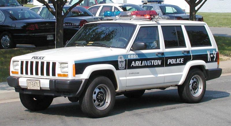 White Jeep Cherokee police SUV with "Arlington Police" text and K-9 designation