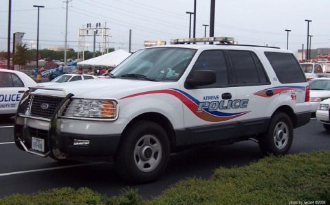 1991 Ford Crown Victoria - Athens Police SUV, likely a Ford Expedition, parked outdoors with other vehicles nearby.