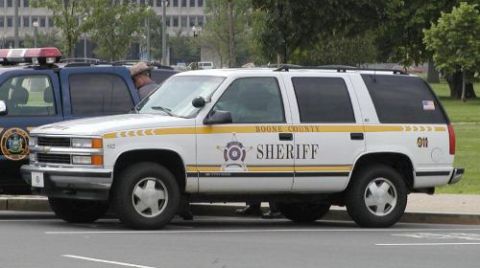 1991 Ford Crown Victoria - A Boone County Sheriff's SUV is parked next to another police vehicle, showing its side profile.