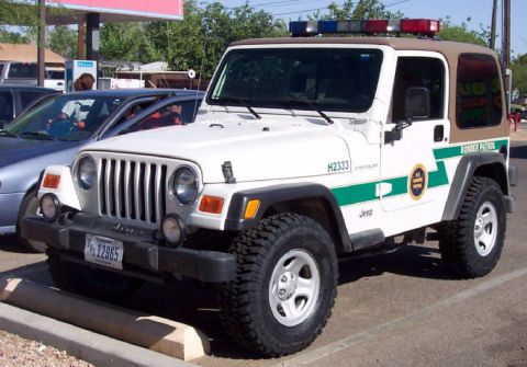 1991 Ford Crown Victoria - This Border Patrol Jeep Wrangler has a light bar on the roof and "Border Patrol" markings on the side.