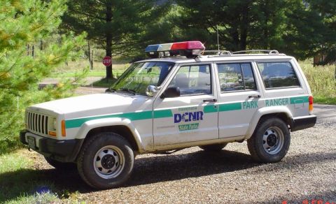 1991 Ford Crown Victoria - Pennsylvania DCNR Park Ranger Jeep Cherokee with a light bar on the roof.