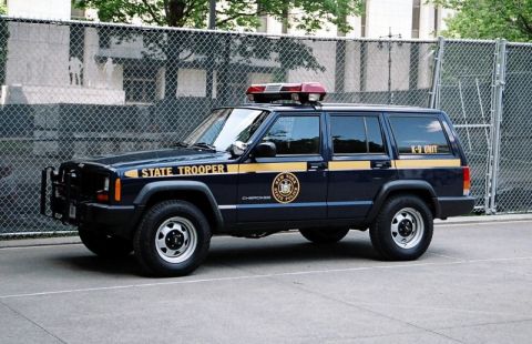 1991 Ford Crown Victoria - This New York State Police Jeep Cherokee is marked as a K-9 unit and features a light bar on the roof.