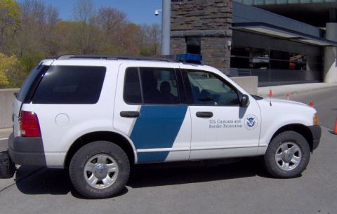 1991 Ford Crown Victoria - This white SUV is marked for U.S. Customs and Border Protection and has a light bar on its roof.