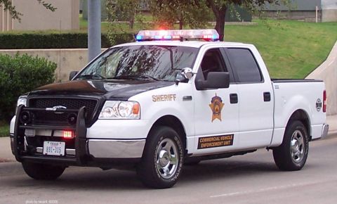 1991 Ford Crown Victoria - Sheriff's pickup truck with "Commercial Vehicle Enforcement Unit" markings and emergency lights.