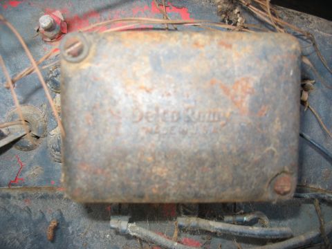 1949 Chevrolet C/K Pickup - A close-up view of a weathered Delco-Remy ignition component, showing signs of age and rust.