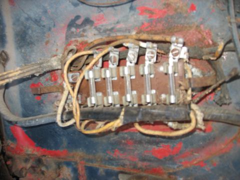 1949 Chevrolet C/K Pickup - Close-up of a vintage fuse block with multiple glass fuses and electrical wiring.