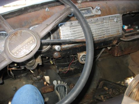 1949 Chevrolet C/K Pickup - The interior of a classic Chevrolet truck shows significant rust and wear on the dashboard and steering wheel.