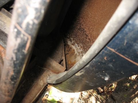 1949 Chevrolet C/K Pickup - Detail of a vehicle's rusted frame and body panel, showing signs of wear and age.