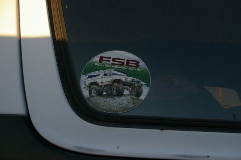 1986 Ford Bronco - A circular sticker on a vehicle window displays a graphic of a lifted Ford Bronco and club information.