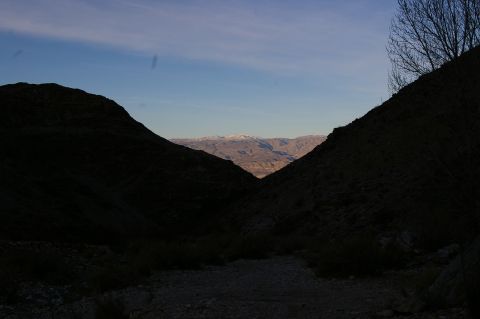 1986 Ford Bronco - A vast mountain landscape unfolds under a clear blue sky, with distant peaks dusted with snow.