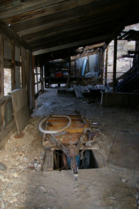 1986 Ford Bronco - Abandoned mine interior shows old equipment and a hole in the floor, likely for ventilation or access.