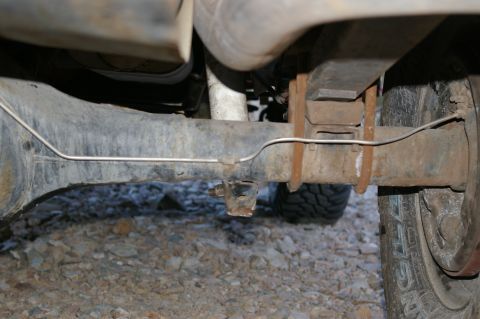 1986 Ford Bronco - Close-up view of the rear axle and suspension of a vehicle.