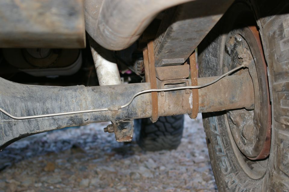 1986 Ford Bronco rear axle with leaf springs and brake drum