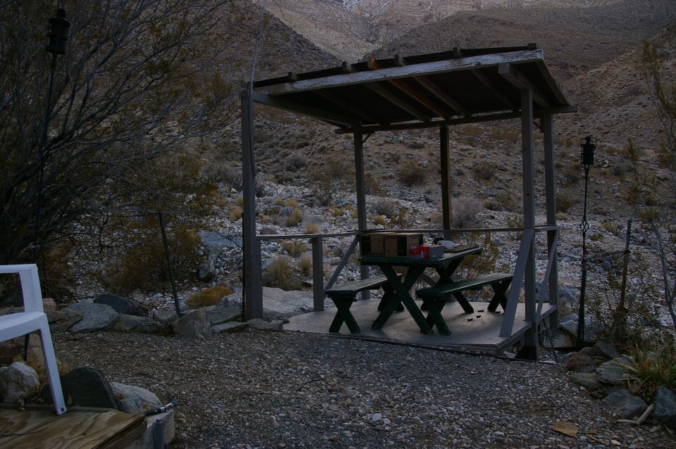 Desert picnic shelter with green table and benches