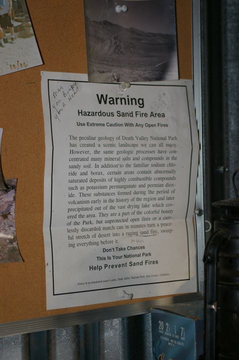 1986 Ford Bronco - A warning sign about hazardous sand fire areas in Death Valley National Park is posted on a bulletin board.