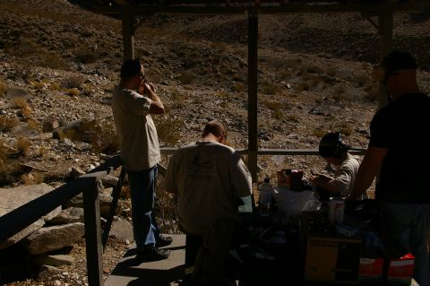 1986 Ford Bronco - Several individuals are seen at a shooting range, some preparing equipment while others observe the surroundings.