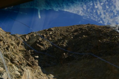 1986 Ford Bronco - The view from inside a vehicle shows a , rocky terrain under a bright blue sky.