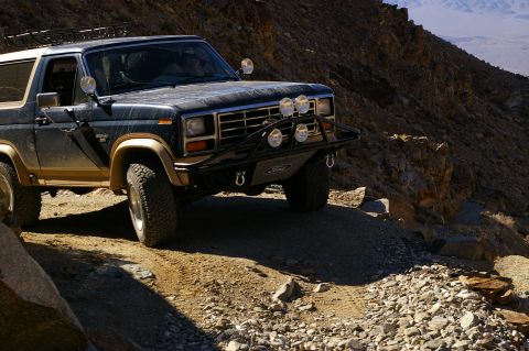1986 Ford Bronco - This 1986 Ford Bronco navigates a rocky, off-road trail under a clear sky.