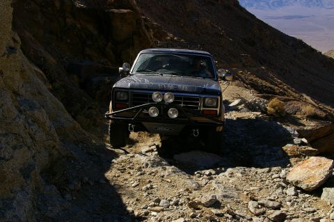 1986 Ford Bronco - This 1980s Ford Bronco navigates a challenging rocky terrain, its off-road capabilities.