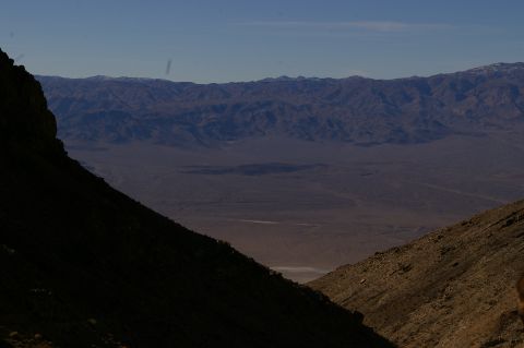 1986 Ford Bronco - A vast desert landscape unfolds, with mountains in the distance and a valley floor stretching out below.