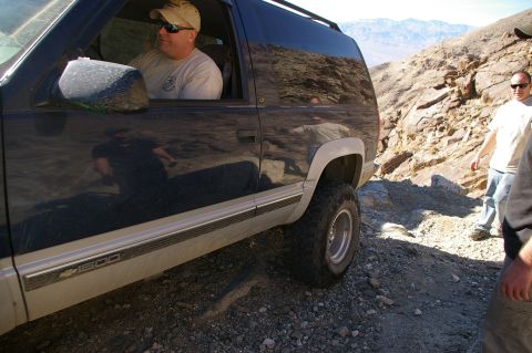 1986 Ford Bronco - Side view of a Chevrolet K1500 pickup truck on a rocky off-road trail.