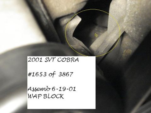 1998 Ford Taurus - A close-up view of an engine part with identifying text and a serial number.