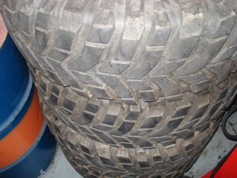 1994 Ford Bronco - Close-up view of stacked off-road tires, showing their aggressive tread pattern.