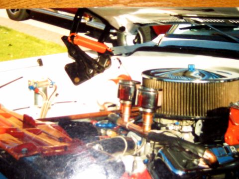 1996 Ford Bronco - Close-up of an engine bay with custom modifications, including an air filter and copper plumbing.