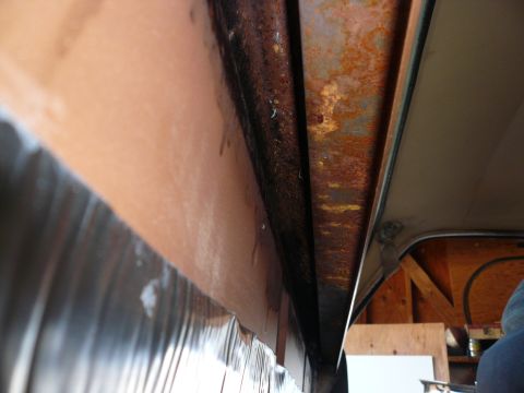 1975 Ford Ranchero - Interior view showing significant rust on metal framing and textured paneling.