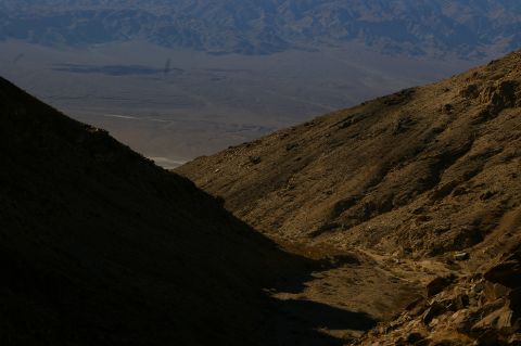 1986 Ford Bronco - A vast desert landscape unfolds, with hills and distant mountains under a clear sky.