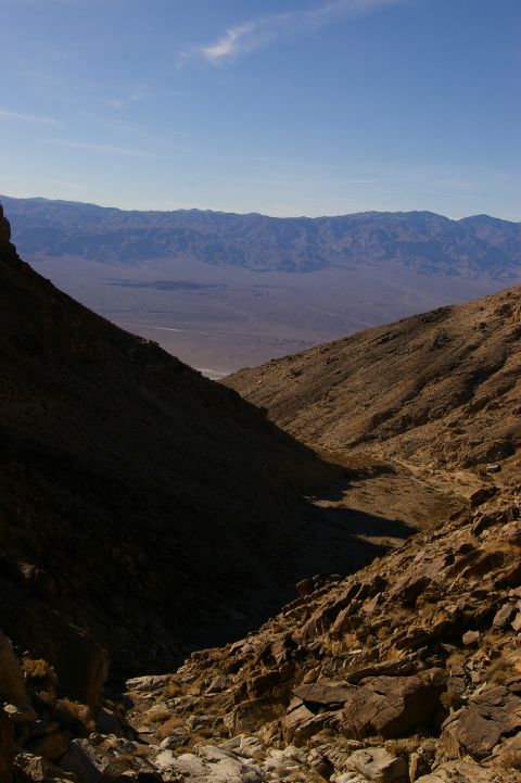 1986 Ford Bronco - A vast desert landscape unfolds, with terrain leading to distant mountains under a bright blue sky.