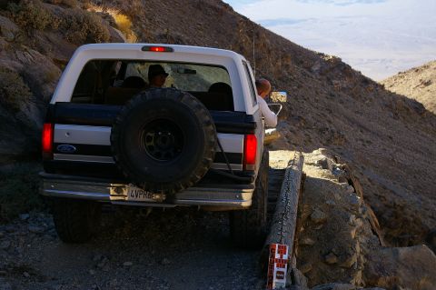1986 Ford Bronco - A 1986 Ford Bronco navigates a treacherous mountain path, its off-road capability.