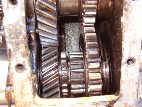 1975 Ford Bronco - The output gear (lower R) is slid rearward on the output shaft to engage the smaller center gear (upper L) providing low-range.