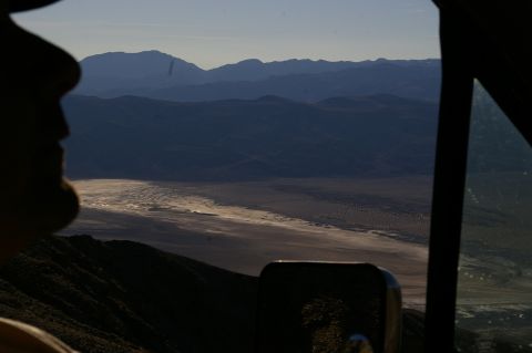 1986 Ford Bronco - Looking out over a dry lake bed and distant mountains from the interior of a vehicle.