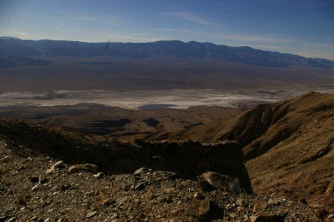 1986 Ford Bronco - A vast desert panorama unfolds, with mountains in the distance and a dry lake bed in the foreground.