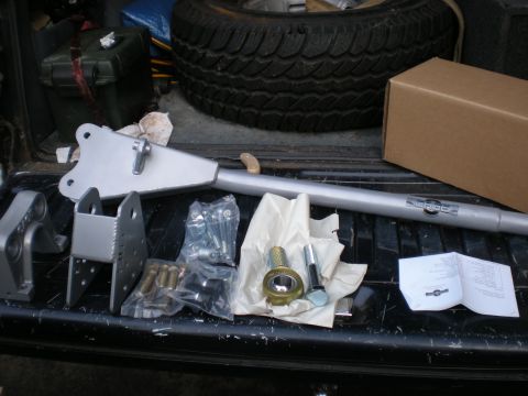 1993 Ford Bronco - Parts for a vehicle suspension upgrade are organized in the bed of a pickup truck.