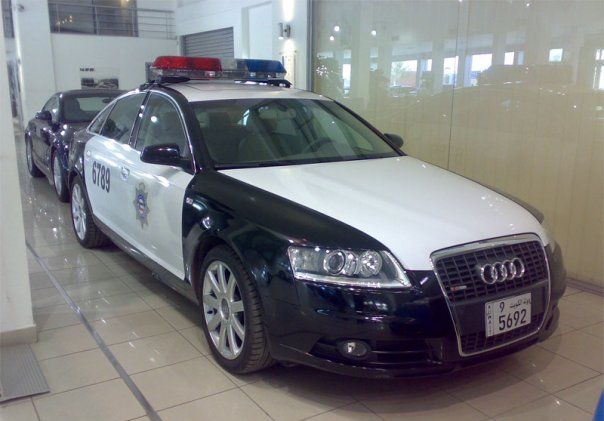 Black and white police car with light bar, license plate 5692