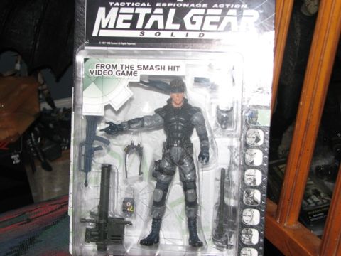 1991 Ford Bronco - Action figure of Solid Snake from Metal Gear Solid, packaged with accessories.