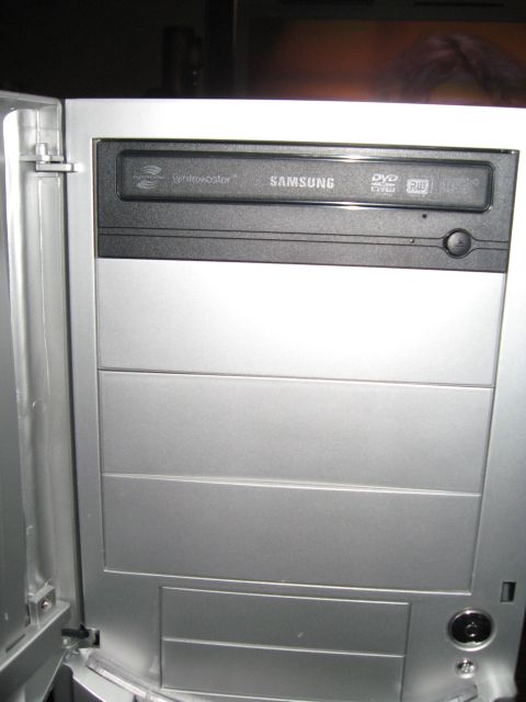 1988 Ford Bronco - A Samsung DVD drive is visible above horizontal drive bays inside a silver computer case.
