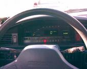 1991 Mazda MX-6 - The interior dashboard of a car is shown, a digital odometer displaying zero miles.
