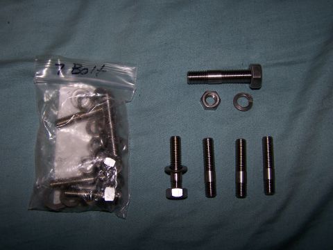 1995 Ford Probe - Hardware assortment including bolts, nuts, and washers, some in a plastic bag.